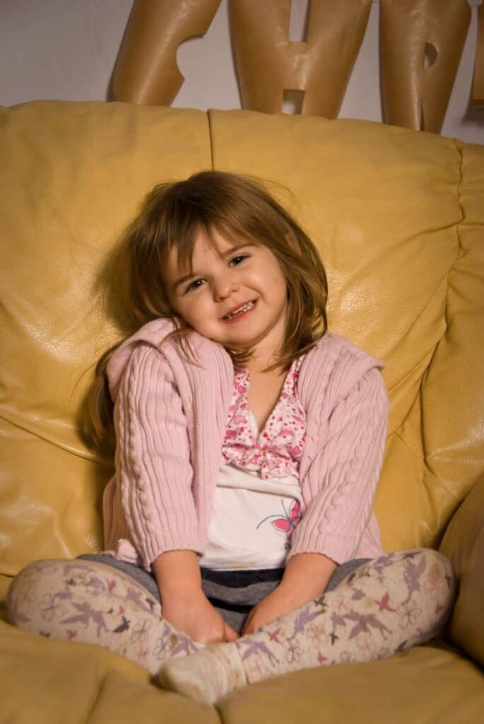 A girl sitting on a chair.