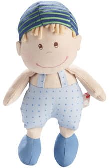 A soft plush doll with light skin, a round face, and stitched brown eyes and smile. The doll has yellow yarn hair, wears a blue and green striped hat, light blue dungarees with polka dots, and matching blue shoes.