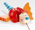 A colourful pull-along toy resembling a cartoonish caterpillar with a segmented blue tail, red body, beige smiling face, blue nose, and orange wings. A red string is attached to the front for pulling.