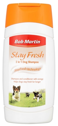 A white bottle of Bob Martin Stay Fresh 2 in 1 Dog Shampoo with an orange cap. The label shows three playful dogs on grass, and text highlights shampoo and conditioner with orange, helping dogs stay fresh for longer.