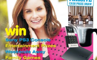 A smiling young woman with long brown hair, wearing a pink polka dot scarf and pink cardigan, stands outdoors. Surrounding her are images of a Sony PS3, mobile phone, camera, and toy cars. Text advertises prize competitions, including cash, gadgets, and games.