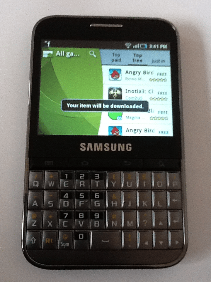 A Samsung smartphone with a physical QWERTY keyboard displays a screen showing a game download notification. The visible game list includes Angry Birds at the top. The phone is black, and the time on the display shows 3:41 pm.