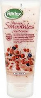 A tube of Radox Shower Smoothies Soul Soother body wash, featuring images of red berries and oats on the label. The tube is mostly white with green, red, and beige accents and text, and the cap is at the bottom.