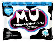 A pack of MU Mature Lighter Cheese, featuring bold white and pink text on a black cow-print background. A blue circle reads "30% LESS FAT," and a white stamp in the bottom right highlights the lighter cheese’s nutritional benefits.