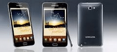 Three Samsung smartphones are displayed: two showing the front with screens on, featuring a stylus and app icons, and one showing the plain back. All phones are black, with the Samsung logo visible on the back and front. The background is a grey gradient.