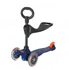 A blue three-wheeled children's scooter with a black handlebar and a circular handle. It has two large front wheels, a smaller rear wheel, and an orange foot brake above the rear wheel. The scooter also has an integrated black seat.