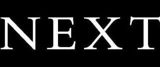 The image shows the word "NEXT" in bold, white capital letters centred on a solid black background. The font is serif and the letters are evenly spaced, creating a strong contrast between the text and background.