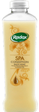 A clear plastic bottle of Radox Spa Conditioner with honey extract. The bottle contains a creamy yellow liquid and features gold illustrations of honeycomb and flowers, with the Radox logo in green and white near the top.
