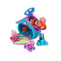 A colourful toy house with a blue roof and purple accents, surrounded by small, brightly coloured cartoon crab and sea creature figurines. The house’s door is open, revealing a play mat inside. Some creatures sit on the roof and beside the house.