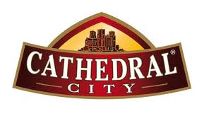 A red and gold logo with an illustration of a cathedral above the bold white text “CATHEDRAL” and the smaller text “CITY” below on a dark red background. The logo has an arched shape and is outlined in gold.