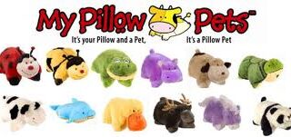 Assorted plush Pillow Pets shaped like various animals, including a ladybird, bumblebee, turtle, purple hippo, cow, dolphin, yellow duck, moose and dog. Above them is the Pillow Pets logo with a cartoon cow and slogan.