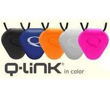 Five Q-Link pendants in black, blue, orange, grey, and pink hang on black cords. Each pendant is teardrop-shaped with a subtle embossed “Q” design. Below them is the text: “Q-Link in colour.”.
