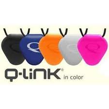 Five Q-Link pendants in black, blue, orange, grey, and pink hang on black cords. Each pendant is teardrop-shaped with a subtle embossed “Q” design. Below them is the text: “Q-Link in colour.”.