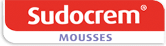 A red and white label with the word "Sudocrem" in bold white letters on a red background, and the word "MOUSSES" in light purple capital letters below on a white background.