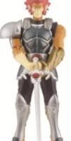 A toy action figure of a male warrior in black and silver armour with a single shoulder pad, red hair, and yellow skin, holding a silver sword vertically with both hands. The figure stands upright against a plain white background.