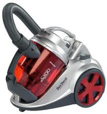 A compact, silver and red Dirt Devil vacuum cleaner with a transparent dust canister, black hose, large rear wheels, and a handle on top for portability. The model name "Power Cyclonic 2500" is visible on the side of the canister.