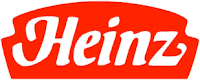 The image shows the Heinz logo with the brand name "Heinz" in bold, white cursive letters on a red, rounded rectangular background. The logo has a retro style, evoking a classic and familiar look often seen on Heinz product packaging.
