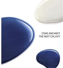 Three glossy, paint-like blobs—one dark blue, one white, and one blue—are arranged on a white background. The text “COME AND MEET THE NEXT GALAXY” appears next to the blobs, suggesting an invitation to a Samsung Galaxy event.