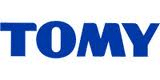The image shows the TOMY logo, featuring the word "TOMY" in bold, blue uppercase letters on a white background. The font is simple, sans-serif, and evenly spaced, conveying a playful yet professional appearance.
