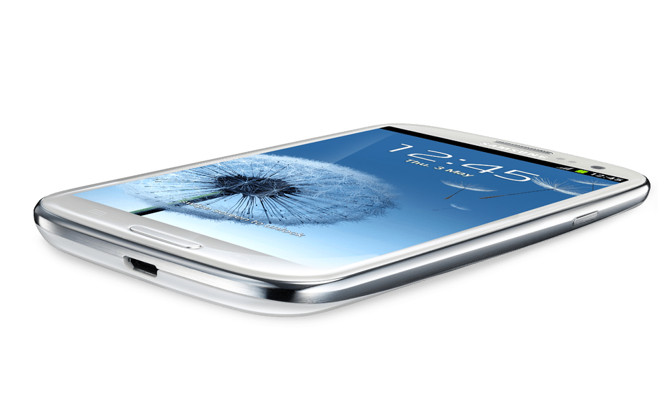 A white smartphone with a curved silver edge lies on a flat surface. Its screen displays a dandelion wallpaper, the time 12:45, and the date Friday, 5 May. The device features a front camera, speaker, and a physical home button.