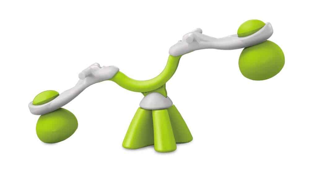 A green and white plastic seesaw toy with rounded seats and bases. The structure has two seats on either end, each supported by a rounded green base, and a central curved support, all designed in a playful, modern style against a white background.