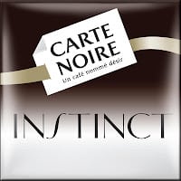 Square logo for Carte Noire Instinct coffee. The background fades from dark brown at the top to white at the bottom. A tilted white label reads "CARTE NOIRE Un café nommé désir," with "INSTINCT" in large, elegant black letters below.