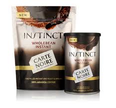Two containers of Carte Noire Instinct Wholebean Instant Coffee are shown: a stand-up pouch and a cylindrical jar. Both have a brown and gold design, with the product name in bold letters and “100% Arabica Coffee” text at the bottom.