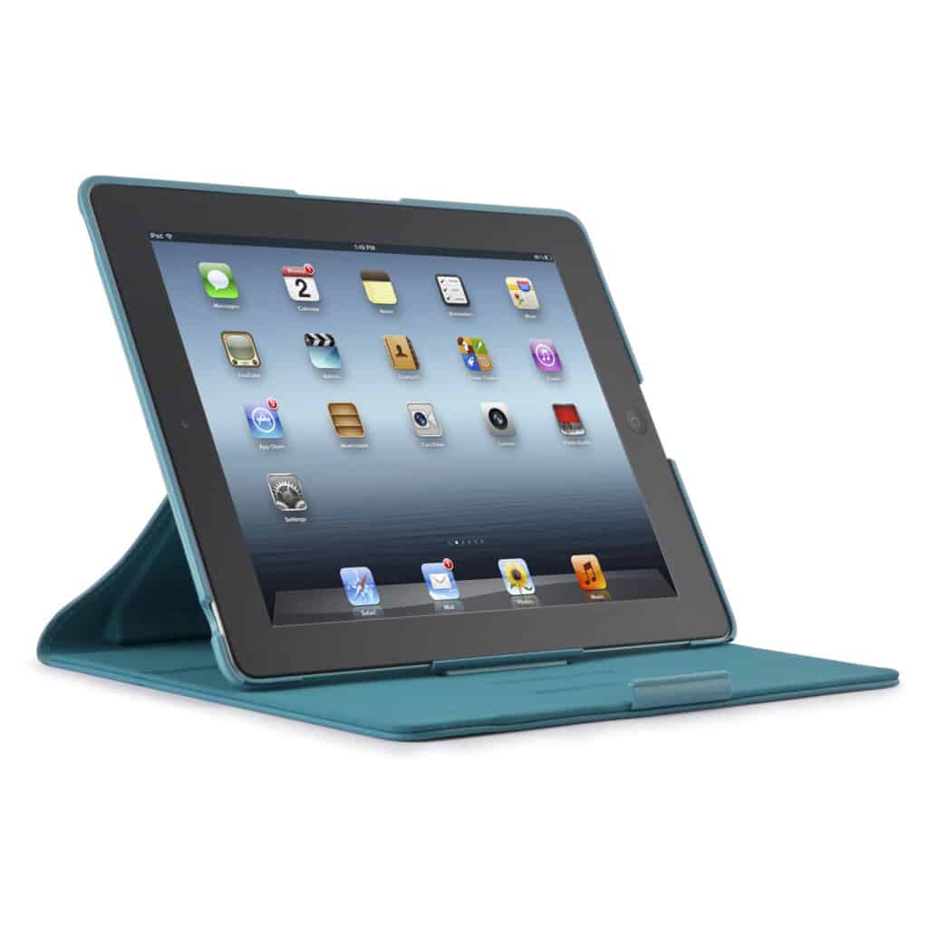 A black tablet with a blue case is propped up in a standing position. The screen displays app icons on a light blue gradient background. The case folds to support the tablet upright, and the photo is taken at an angle from the left front side.