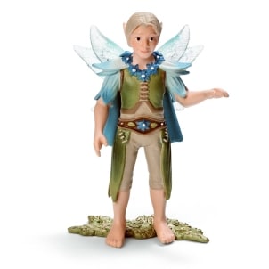 A figurine of a fairy boy with light skin, blond hair, and pointed ears. He has translucent blue wings, a green and blue outfit with leaf details, a jewelled belt, and bare feet. He stands on a textured green base, with one arm slightly raised.