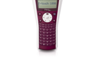 A maroon and white Brother P-touch 1080 handheld label maker stands upright on a white background. The LCD screen displays "P-touch 1080." The device has a full QWERTY keyboard, control buttons, and a visible label emerging from the top.