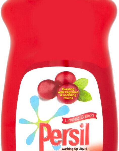A red bottle of Persil limited edition washing-up liquid called "Warm Spice." The label features cranberries, mint leaves, snowflake graphics, and text reading "Bursting with fragrance, powerful results." The bottle has a clear flip-top cap.