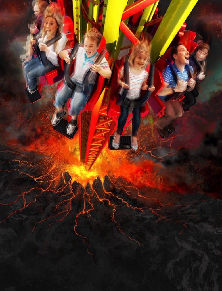 Six people are strapped into a vertical amusement park ride, screaming and smiling as they are lifted above a fiery, erupting volcano with glowing lava cracks below, creating an intense, thrilling atmosphere.