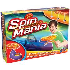 Colourful box for the game "Spin Mania" featuring a smiling child spinning a yellow and orange disc. The background is blue and green with spinning discs, and the text reads “The Speeding, Spinning, Time Trial Challenge!”.