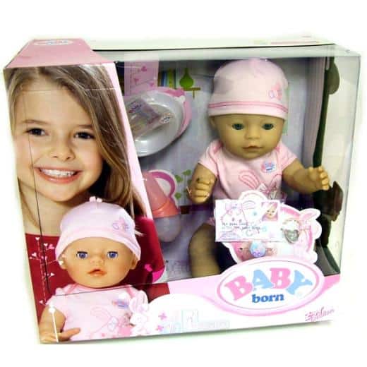 A boxed BABY born doll set includes a lifelike baby doll dressed in pink clothes and hat, plus accessories like a bottle. The packaging features a photo of a smiling young girl and images of the doll. The logo "BABY born" is visible on the lower right-hand side.