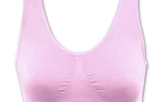 A seamless, light pink sports bra is shown on a white background. It features wide shoulder straps, a scoop neckline, and a ribbed band under the bust for support. The fabric appears smooth and stretchy, with no visible clasps or fastenings.
