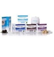 A group of Fade Out skincare products, including creams, a serum, and cleansing items, are neatly arranged in two rows on a white background. The packaging is mainly white with blue, purple, and teal accents, and some products have small natural ingredients beside them.