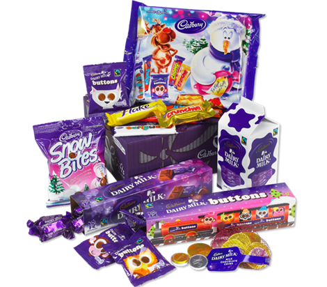 A variety of Cadbury chocolates and sweets in purple packaging, including Dairy Milk bars, Snow Bites, Buttons, Flake, Crunchie, coins, and gift boxes, arranged together with festive and cartoon designs visible on some wrappers.