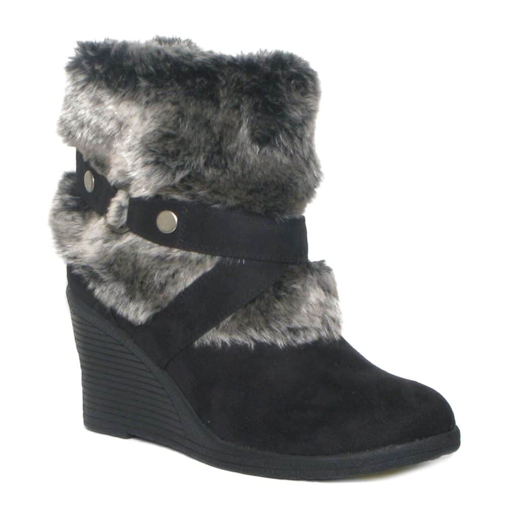 A black suede wedge-heeled ankle boot with thick grey faux fur trim around the top and middle. Decorative black straps with silver buttons criss-cross the ankle area. The sole is ridged, and the boot has a rounded toe.
