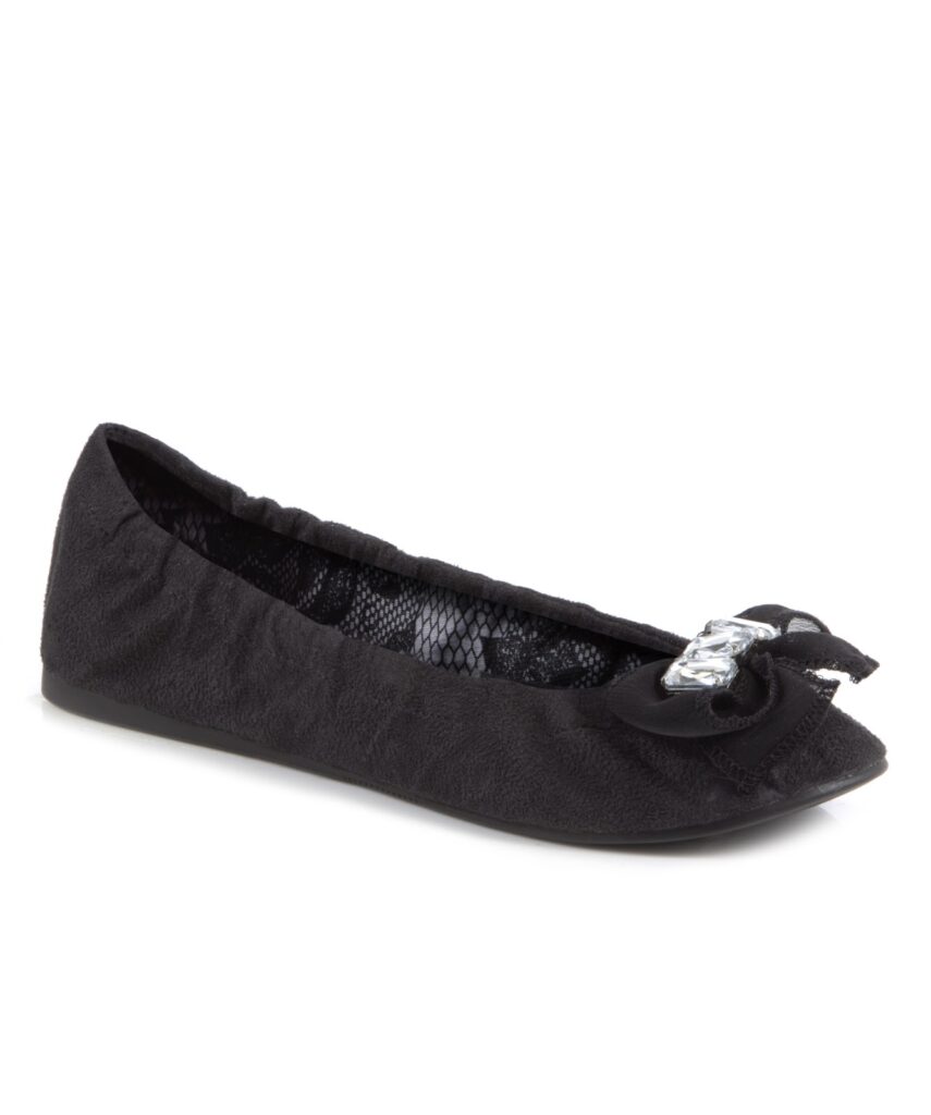 A single black ballet flat with a textured fabric finish, featuring a decorative bow and a silver rectangular embellishment on the toe, and an elasticated edge for a snug fit. The inner lining has a patterned design.