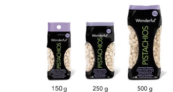 Three bags of Wonderful Pistachios in different sizes (150g, 250g, and 500g) are shown side by side. The bags are black with a clear window revealing the pistachios inside and green text reading "PISTACHIOS" vertically on each bag.