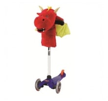 A children’s scooter with a blue deck and two front wheels. Attached to the handlebar is a large, plush red dragon head with yellow horns and ears, green wings, and an open mouth, giving the scooter a whimsical, fantasy-inspired look.