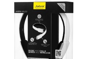 A retail package of Jabra Halo2 headphones is shown. The box is clear with black sides and a yellow Jabra logo on top. Inside, white and black headphones are visible. Text highlights features: music and calls, wired and wireless, and Bluetooth capability.