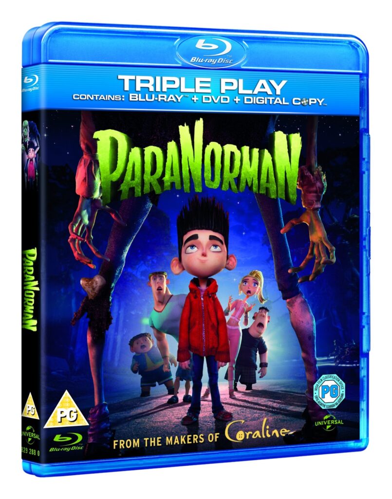 Blu-ray case for the animated film “ParaNorman.” The cover shows Norman, a boy with spiked hair, standing with frightened children and a dog as zombie hands emerge from the ground. The title glows green above them. Banner reads "Triple Play: Blu-ray + DVD + Digital Copy.