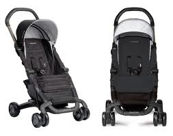 Two black baby pushchairs are shown side by side against a white background. Both have four wheels, a canopy, harness straps, and curved handles. The pushchair on the left is angled, showing details of the seat, while the right pushchair is shown from the front.