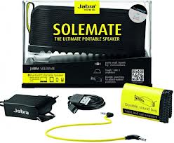 Retail packaging for the Jabra Solemate portable speaker, featuring the black speaker, yellow accents, a USB charging cable, a 3.5mm audio cable, a carrying bag, and product branding with the tagline “The Ultimate Portable Speaker”.