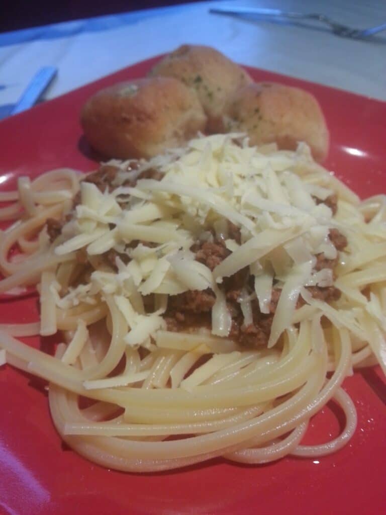 A plate of spaghetti and cheese.