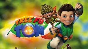 Animated image shows two characters from the show "Tree Fu Tom." Tom, a boy in green and blue, is flying with a fist forwards. A smaller character in an acorn hat is beside him. The colourful “Tree Fu Tom” logo appears behind them against a leafy background.