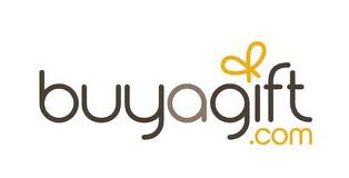 The image shows the "buyagift.com" logo in lowercase black letters. The dot above the letter "i" is stylised as a yellow bow, and ".com" appears in smaller yellow font below the "f" and "t". The background is white.