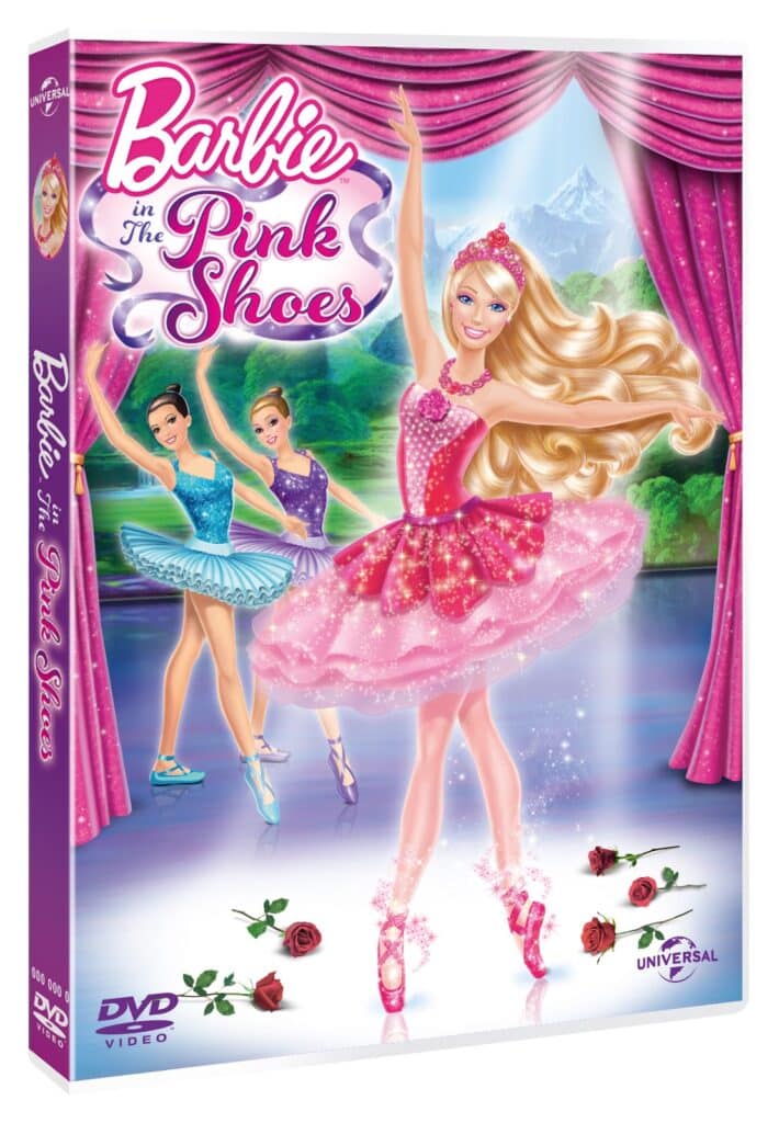 DVD cover of “Barbie in The Pink Shoes.” Barbie, in a pink tutu and ballet shoes, dances centre stage. Two ballerinas are behind her, with a mountain and lake in the background. Pink curtains frame the scene, and roses and sparkles decorate the cover.