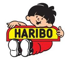 Cartoon boy with black hair, wearing a red outfit and white trainers, smiles whilst leaning over a yellow sign with red edging that says "HARIBO" in bold black letters. The background is plain white.